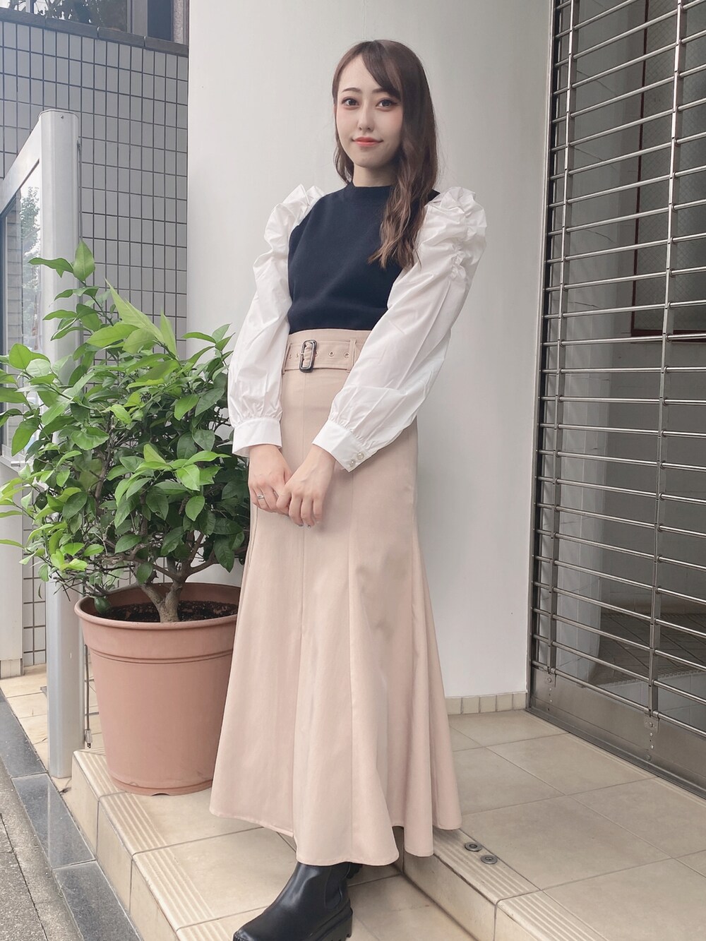 ベージュ系のスカートを着用したレディースの夏コーディネートの2枚目の写真