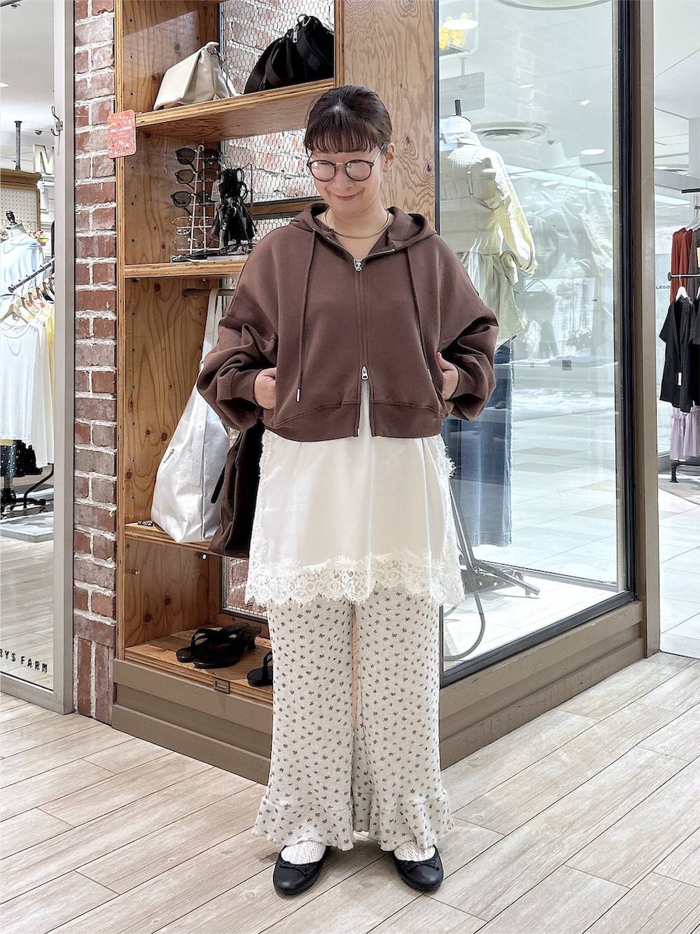 グレー系のその他パンツ、ブラック系のバレエシューズ、ホワイト系のキャミソールを着用したレディースの秋コーディネートの2枚目の写真