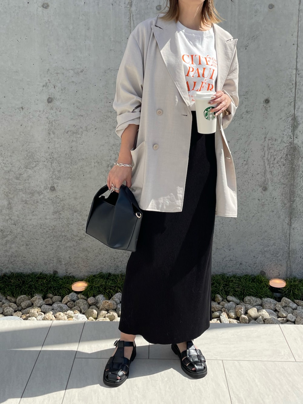 ブラック系のショルダーバッグ、オレンジ系のTシャツ/カットソー、グレー系のテーラードジャケットを着用したレディースの夏コーディネートの2枚目の写真