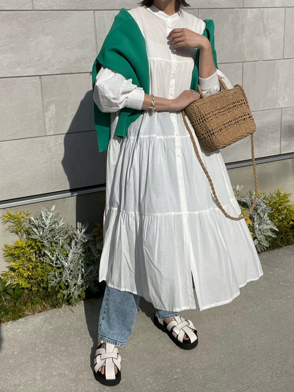 ホワイト系のワンピース、ホワイト系のサンダル、グリーン系のカーディガン/ボレロを着用したレディースの春コーディネートの2枚目の写真