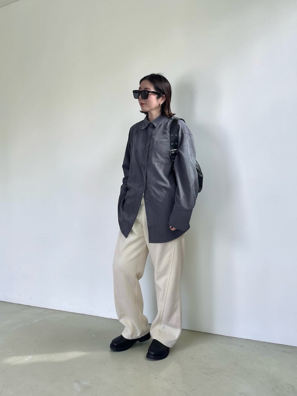 ホワイト系のスウェットパンツ、グレー系のシャツ/ブラウス、ブラック系のハンドバッグを着用したレディースの春コーディネートの5枚目の写真