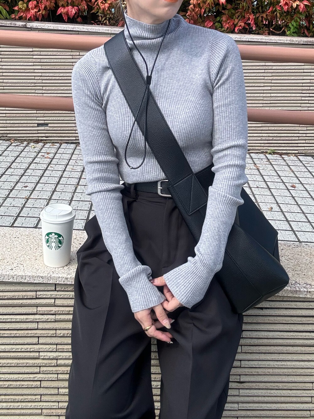 グレー系のニット/セーター、ブラック系のその他パンツ、ブラック系のスニーカーを着用したレディースの秋コーディネートの4枚目の写真