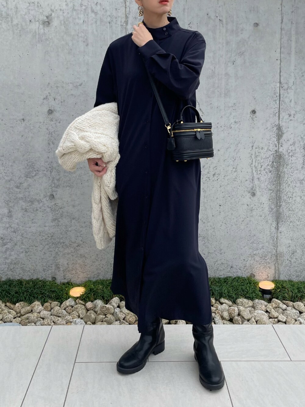 ブルー系のワンピース/ドレス、ブラック系のブーツ、ホワイト系のカーディガン/ボレロを着用したレディースの秋コーディネートの2枚目の写真