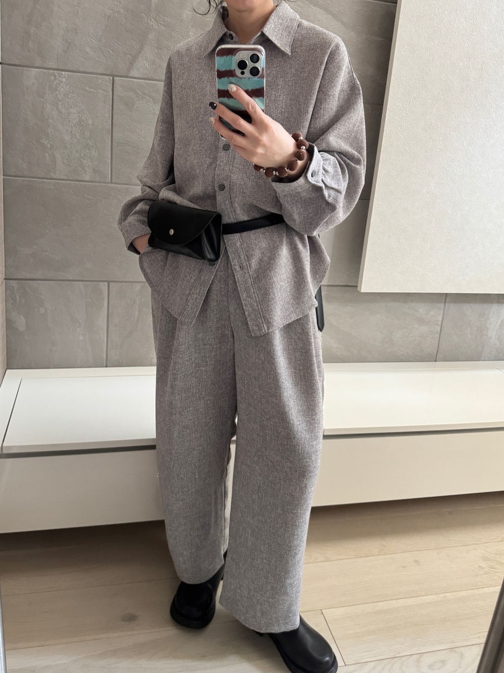 グレー系のシャツ/ブラウス、グレー系のスラックス、ブラック系のその他シューズを着用したレディースの春コーディネートの3枚目の写真