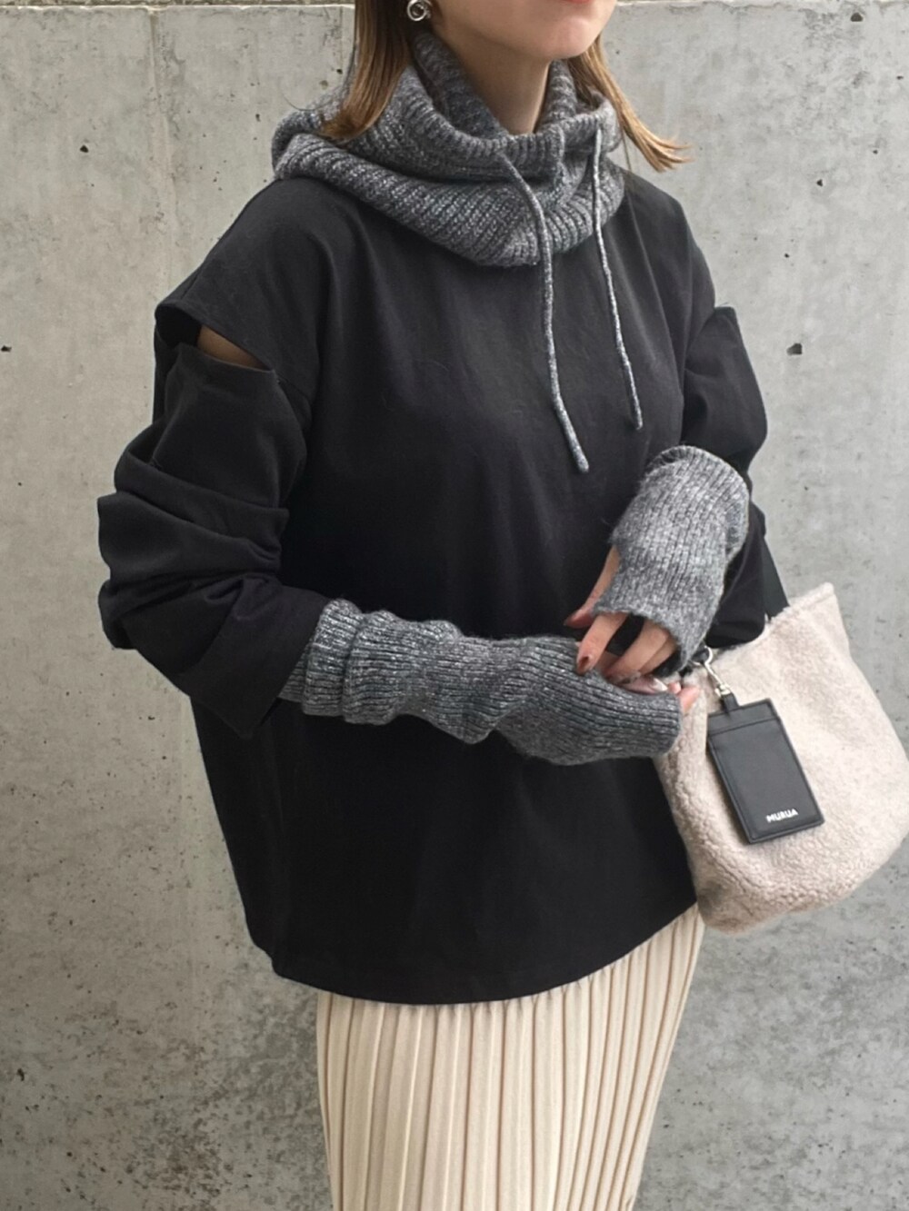 ブラック系のTシャツ/カットソー、グレー系のトートバッグ、ブラック系のブーツを着用したレディースの秋コーディネートの4枚目の写真