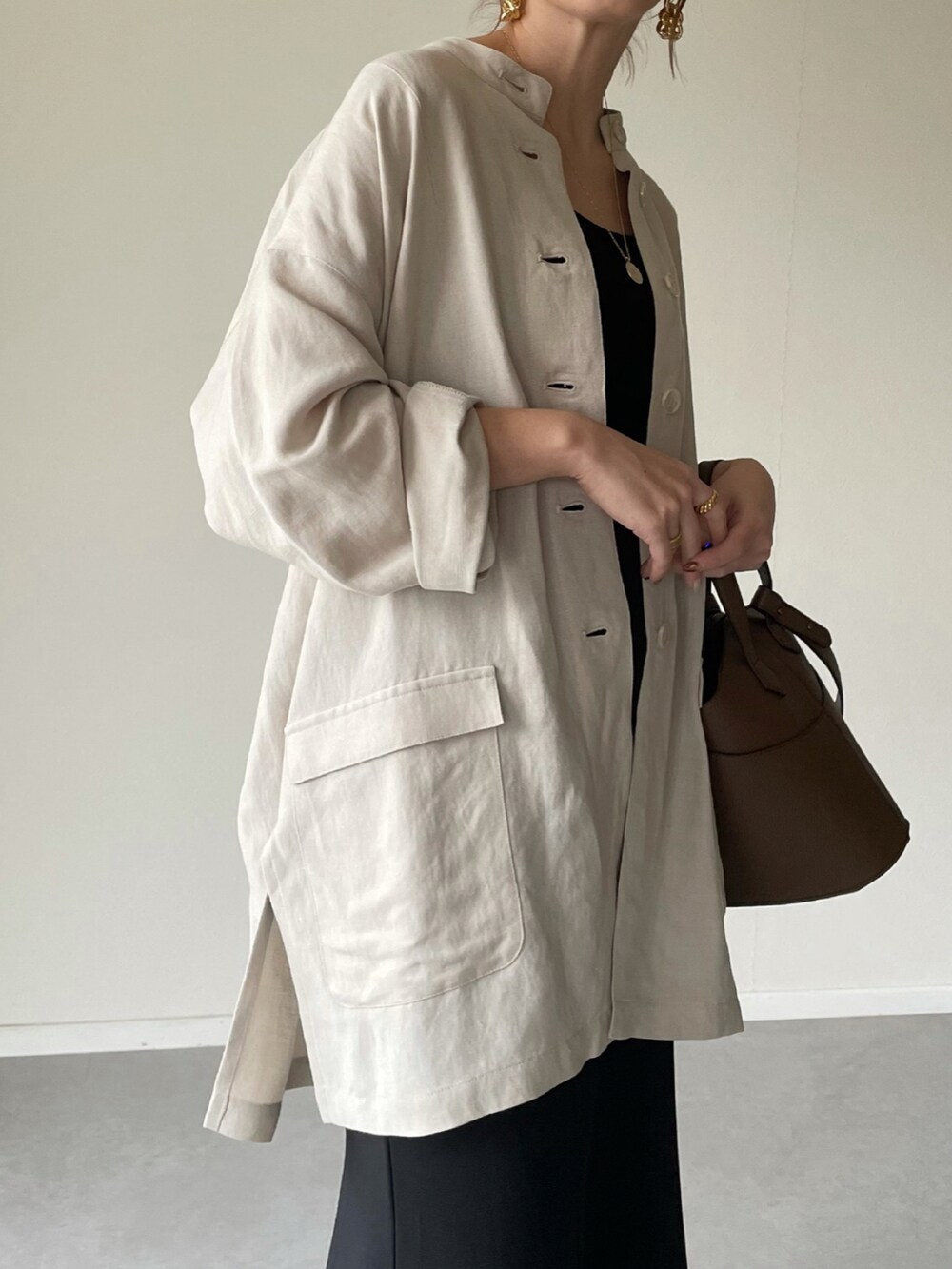 ベージュ系のその他アウター、ブラック系のスカート、ブラウン系のショルダーバッグを着用したレディースの冬コーディネートの4枚目の写真