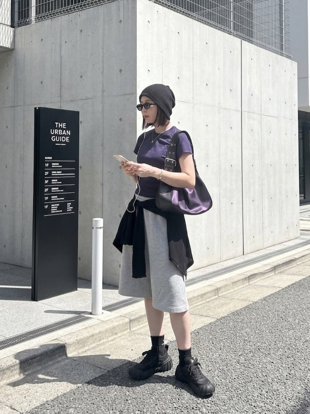 ブラック系のカーディガン/ボレロ、ブラック系のハンドバッグ、ブラック系のスニーカーを着用したレディースの夏コーディネートの2枚目の写真