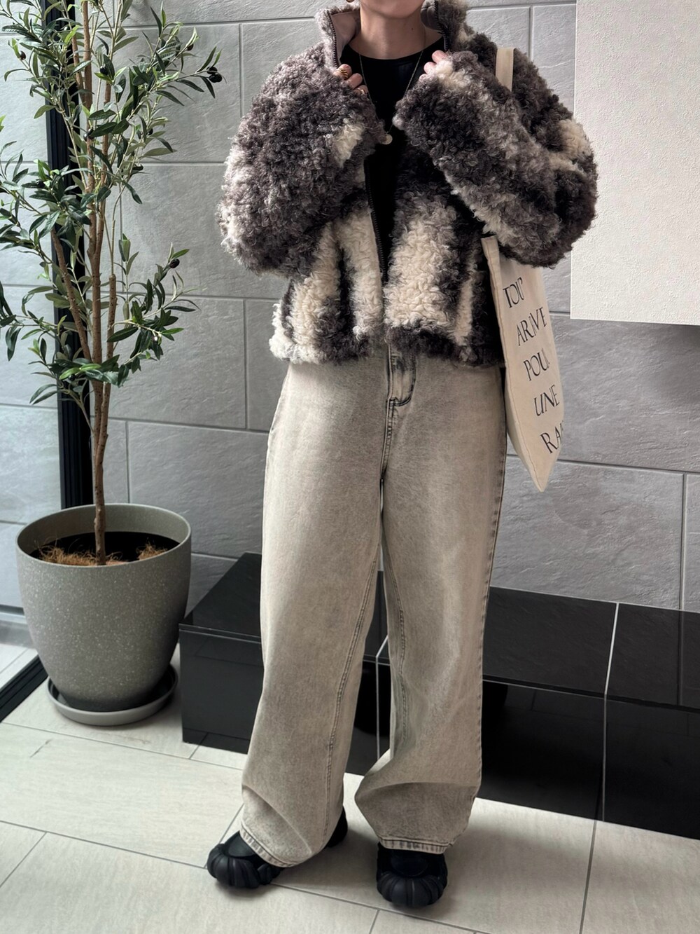 ベージュ系のデニムパンツ、ブラック系のスニーカーを着用したレディースの秋コーディネートの4枚目の写真