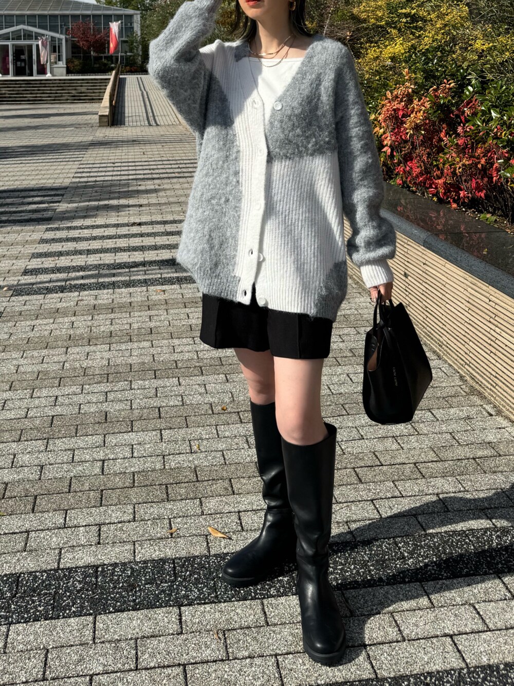 ブラック系のその他パンツ、ブラック系のハンドバッグ、ホワイト系のキャミソールを着用したレディースの秋コーディネートの2枚目の写真