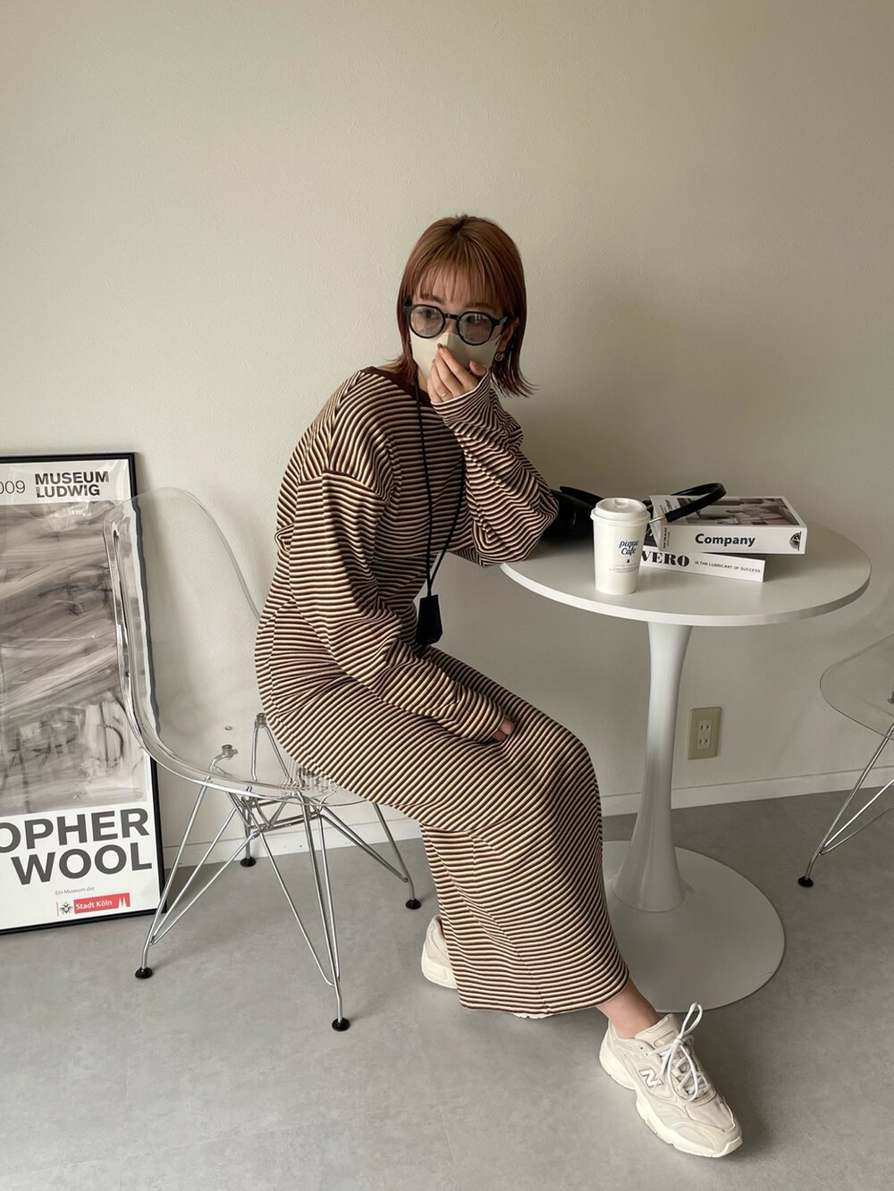 ブラウン系のワンピース、ブラック系のハンドバッグ、グリーン系のMA-1を着用したレディースの春コーディネートの5枚目の写真