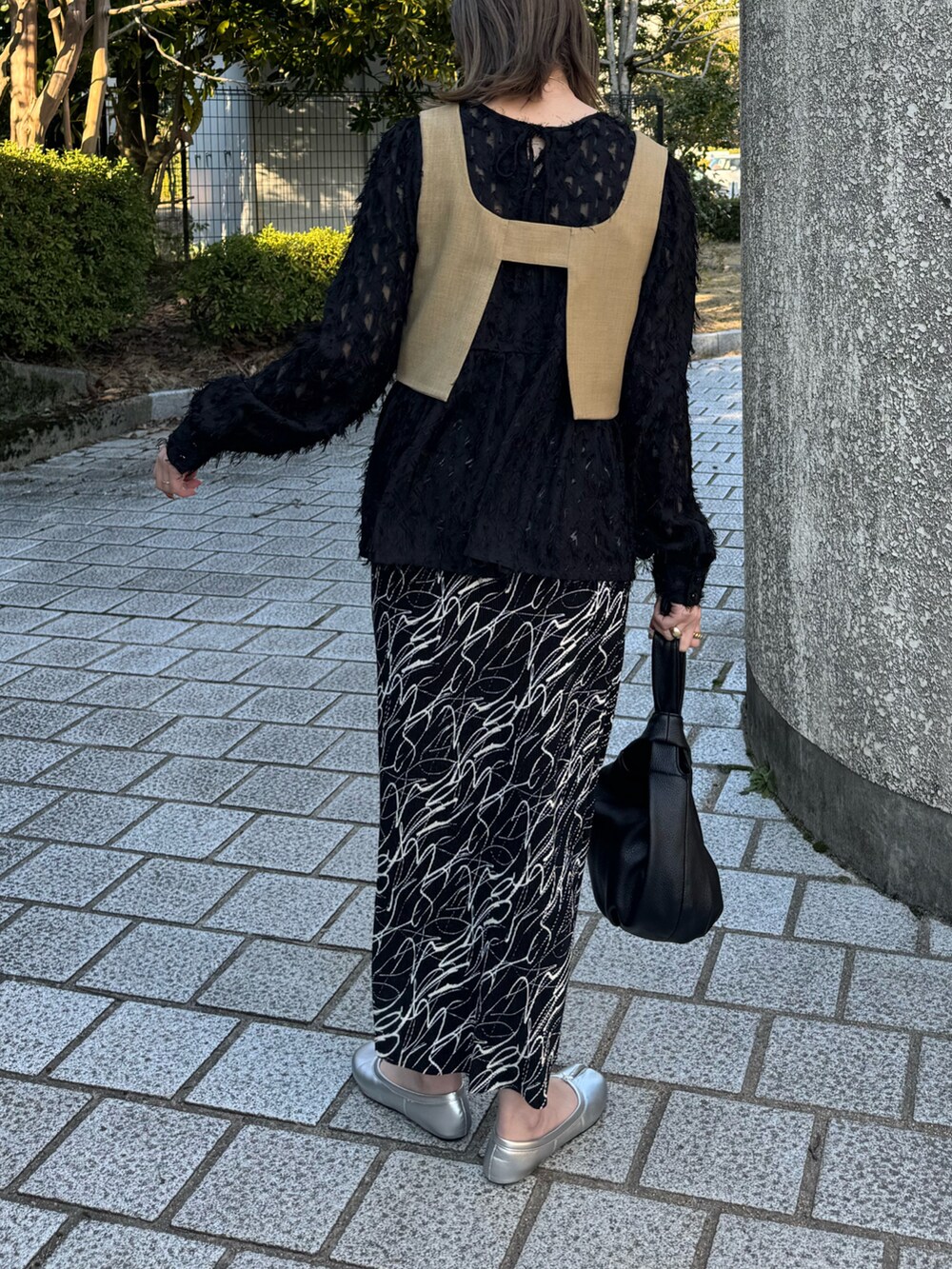 ベージュ系のキャミソール、ブラック系のシャツ/ブラウス、ブラック系のスカートを着用したレディースの春コーディネートの3枚目の写真