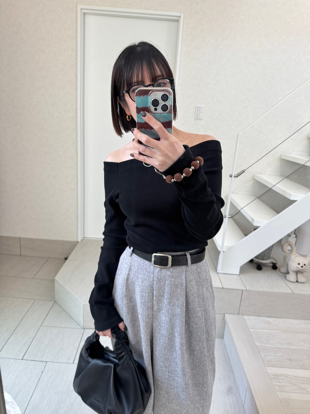 ブラック系のTシャツ/カットソー、ブラック系のショルダーバッグ、グレー系のスラックスを着用したレディースの夏コーディネートの2枚目の写真