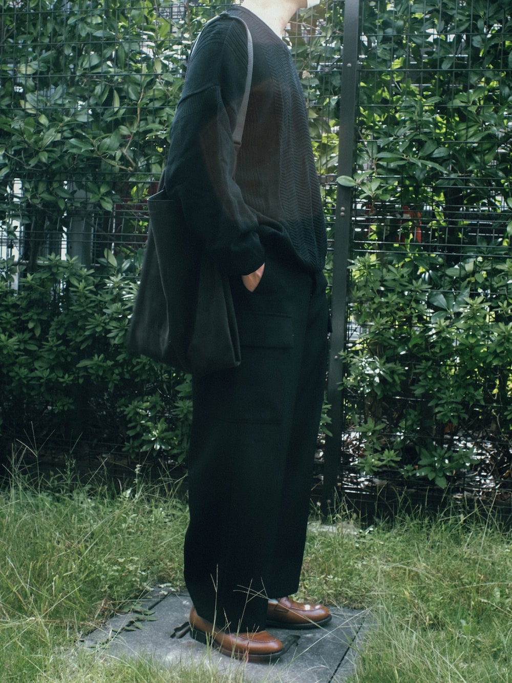 ブルー系のニット/セーター、ブラック系のカーゴパンツ、ブラウン系のローファーを着用したメンズの秋コーディネートの2枚目の写真