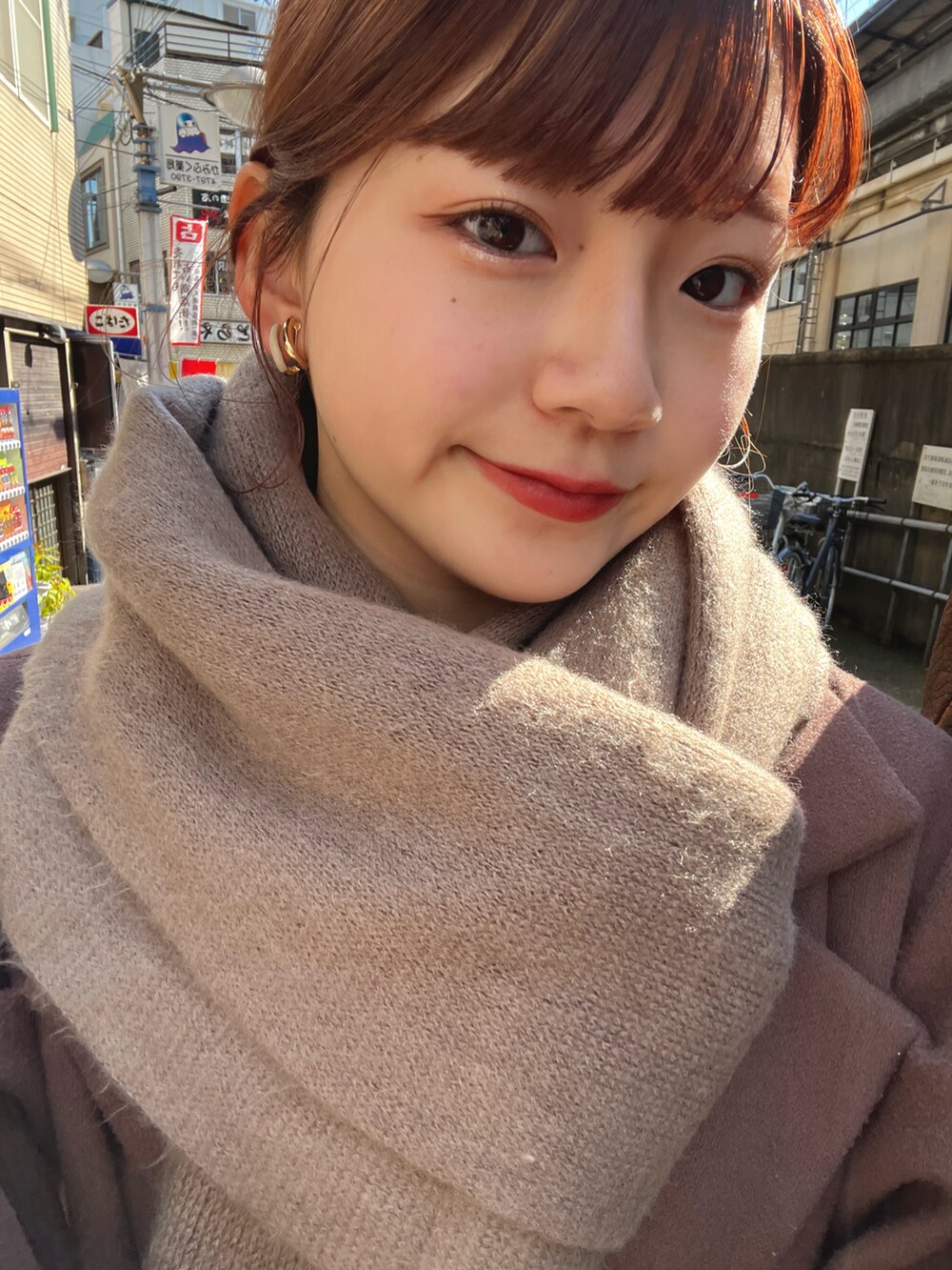 ベージュ系のワンピースを着用したレディースの冬コーディネートの2枚目の写真