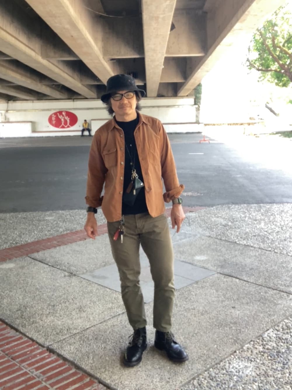 ブラック系のTシャツ/カットソー、ブラウン系のシャツ/ブラウス、グリーン系のパンツを着用したメンズの春コーディネートの3枚目の写真
