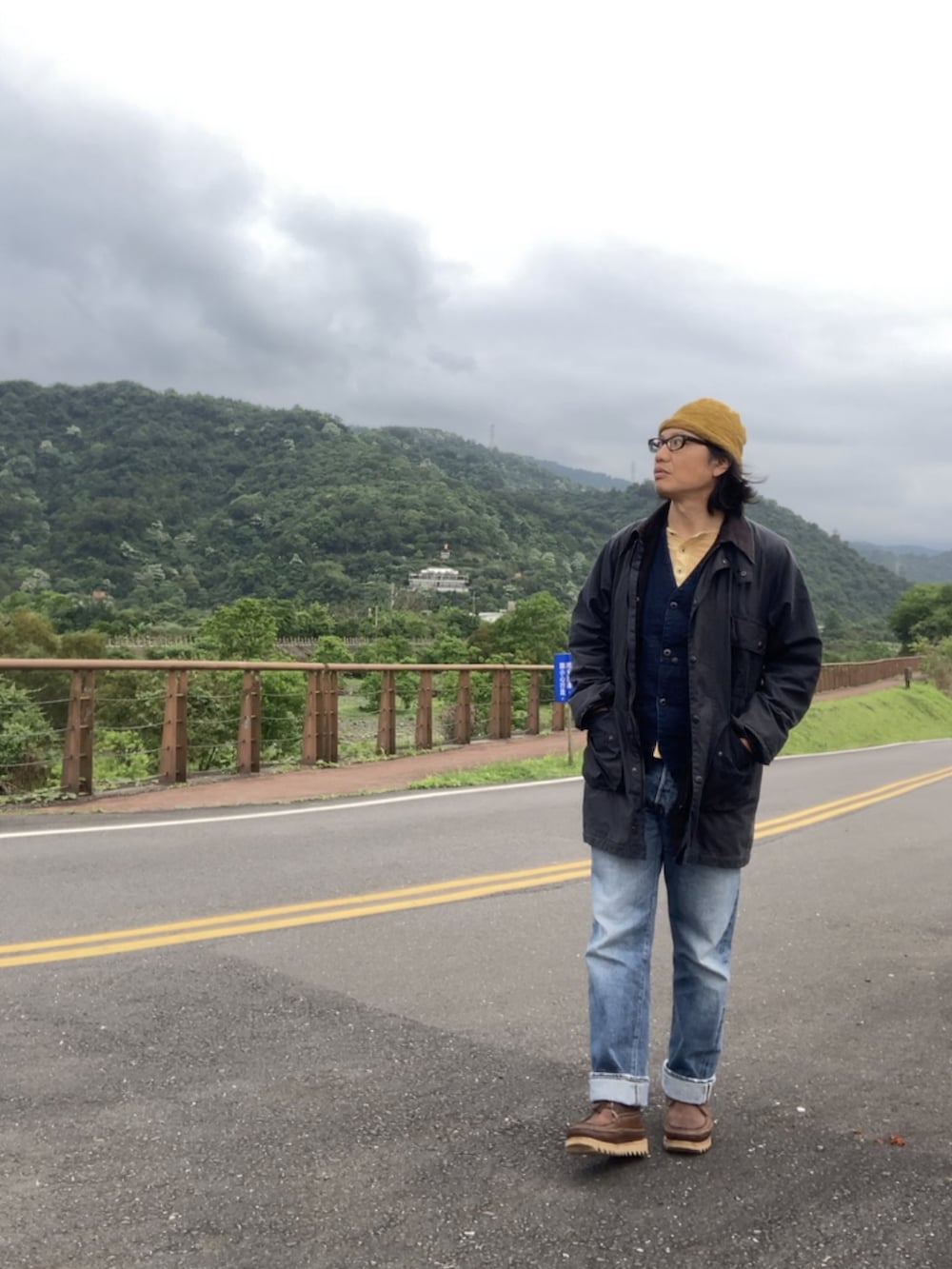 ブラウン系のブーツ、ブルー系のベスト、ブルー系のその他アウターを着用したメンズの春コーディネートの2枚目の写真