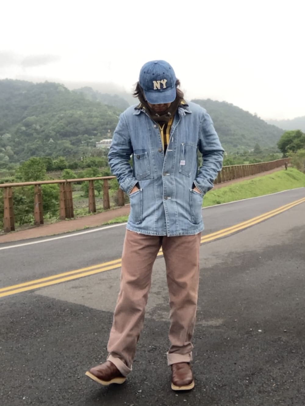 ブルー系のカバーオール、ブラウン系のスリッポン、イエロー系のシャツ/ブラウスを着用したメンズの春コーディネートの2枚目の写真