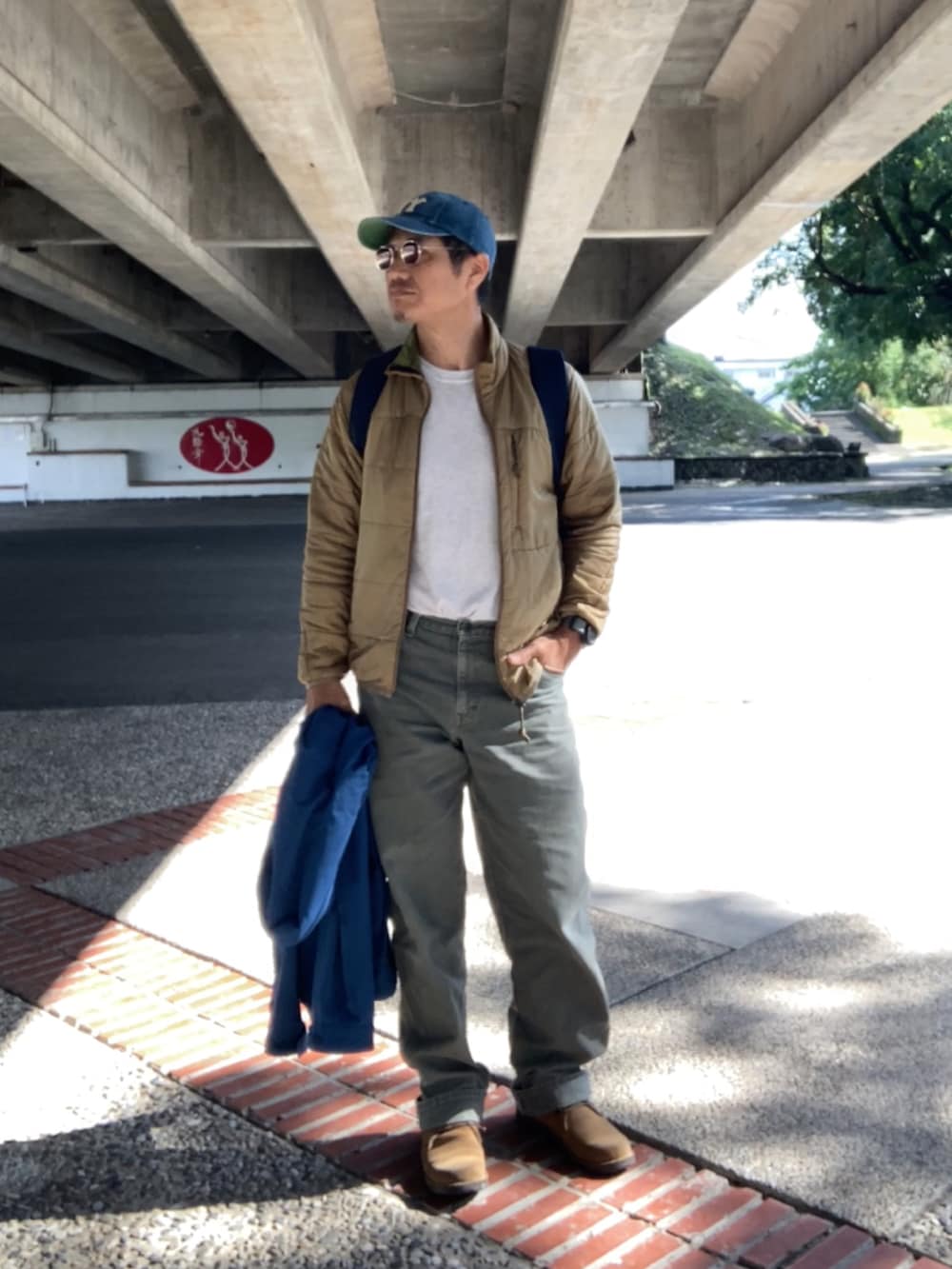 グレー系のTシャツ/カットソー、ブラウン系のその他トップス、ブルー系のマウンテンパーカーを着用したメンズの冬コーディネートの2枚目の写真