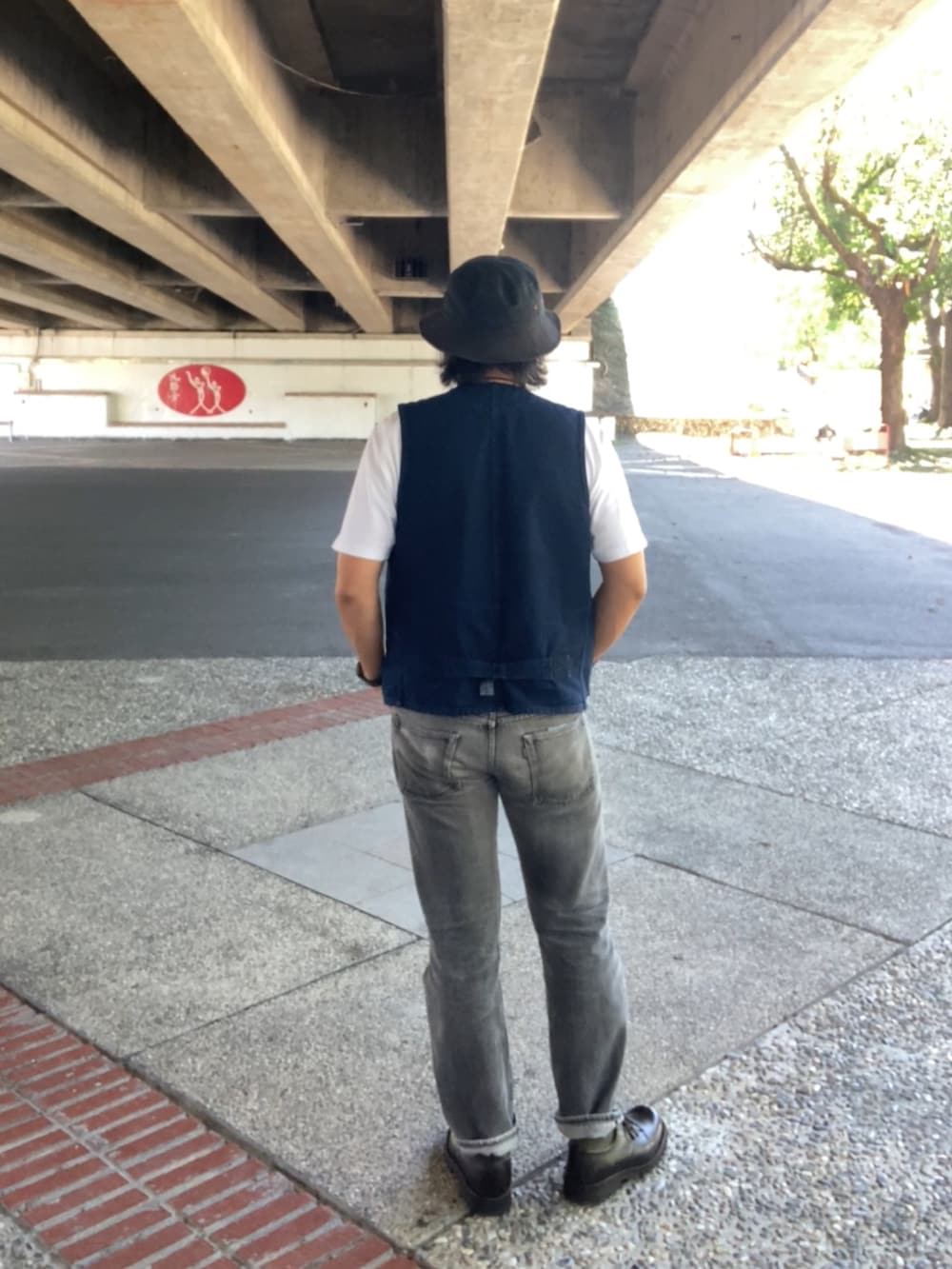 ブルー系のベスト、ホワイト系のTシャツ/カットソー、ブラック系のデニムパンツを着用したメンズの夏コーディネートの3枚目の写真