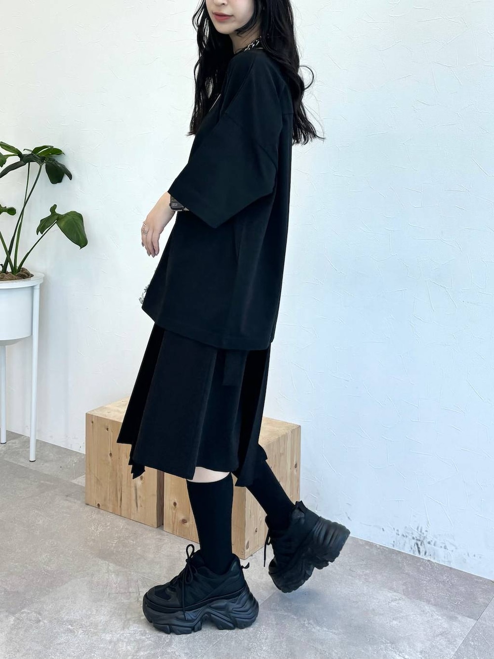 ブラック系のスニーカー、シルバー系のショルダーバッグ、ブラック系のスカートを着用したレディースの春コーディネートの4枚目の写真