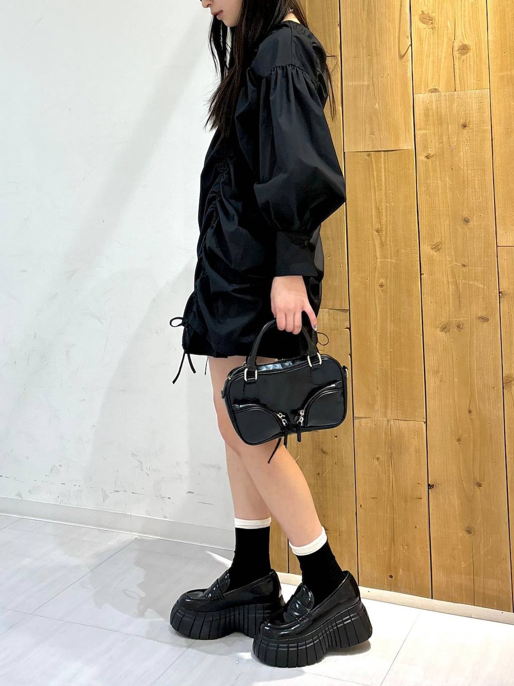 ブラック系のワンピース、ブラック系のローファー、ブラック系のボストンバッグを着用したレディースの春コーディネートの3枚目の写真