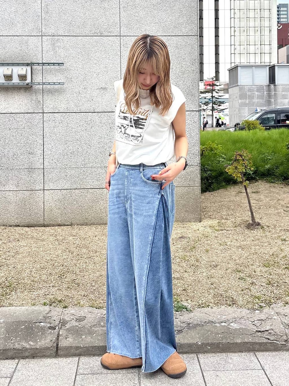 ブルー系のデニムパンツ、ホワイト系のショルダーバッグ、ホワイト系のTシャツ/カットソーを着用したレディースの夏コーディネートの4枚目の写真