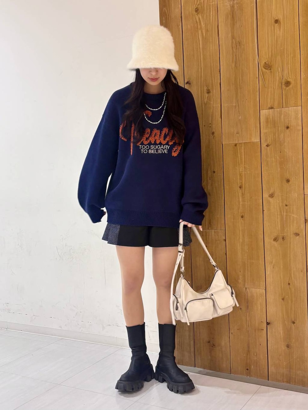 ブラック系のショルダーバッグ、ブルー系のニット/セーター、ブラック系のその他パンツを着用したレディースの冬コーディネートの6枚目の写真