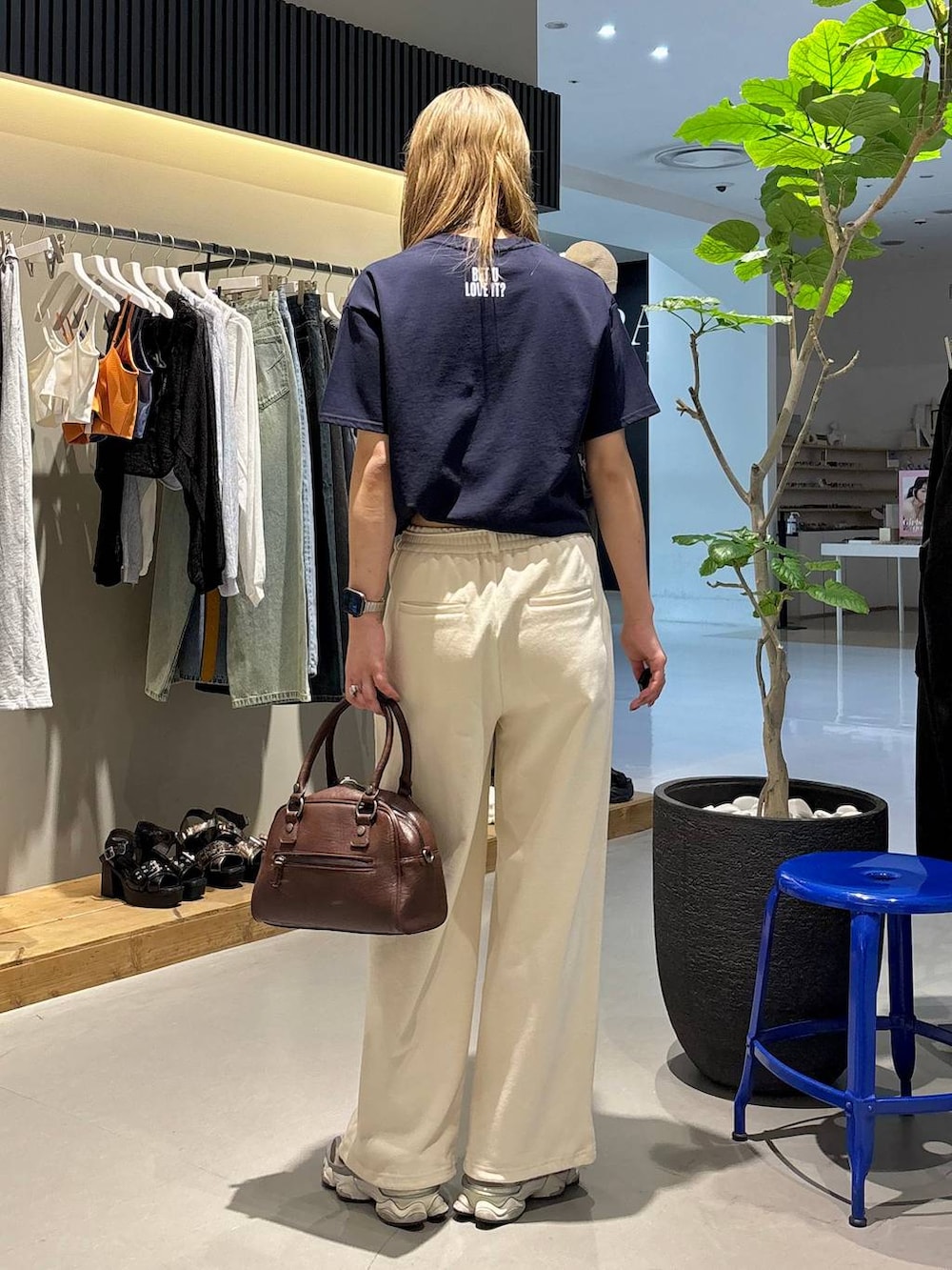 ブルー系のTシャツ/カットソー、ブラウン系のショルダーバッグ、ホワイト系のスウェットパンツを着用したレディースの夏コーディネートの5枚目の写真