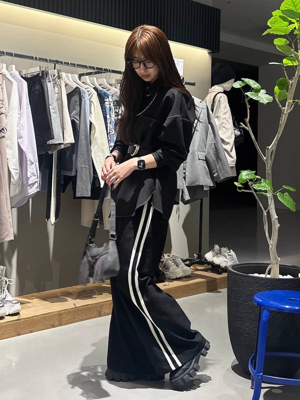 ブラック系のショルダーバッグ、ブラック系のスラックス、ブラック系のシャツ/ブラウスを着用したレディースの冬コーディネートの5枚目の写真