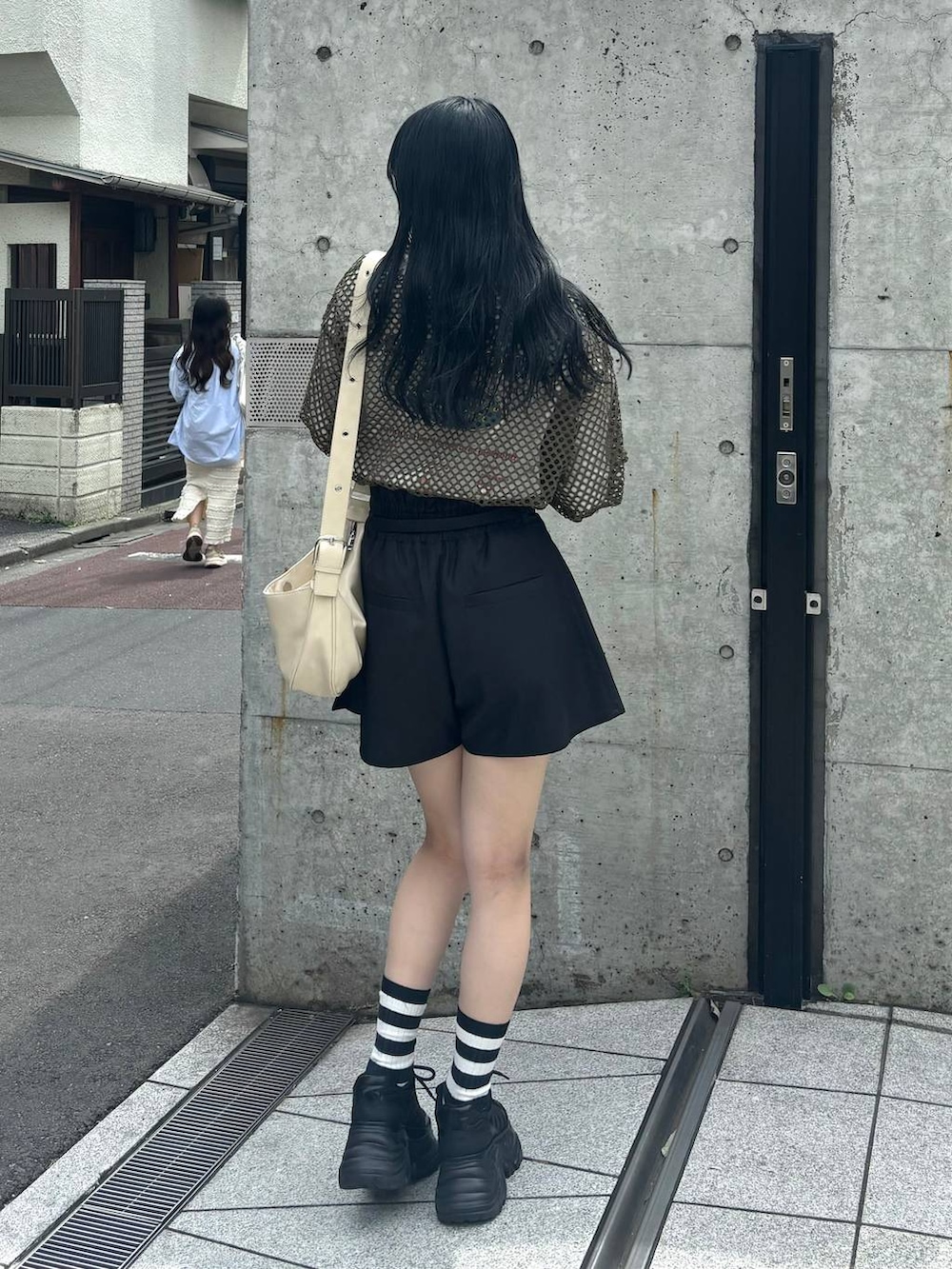 ブラック系のスニーカー、ブラック系のその他パンツ、グリーン系のTシャツ/カットソーを着用したレディースの夏コーディネートの4枚目の写真