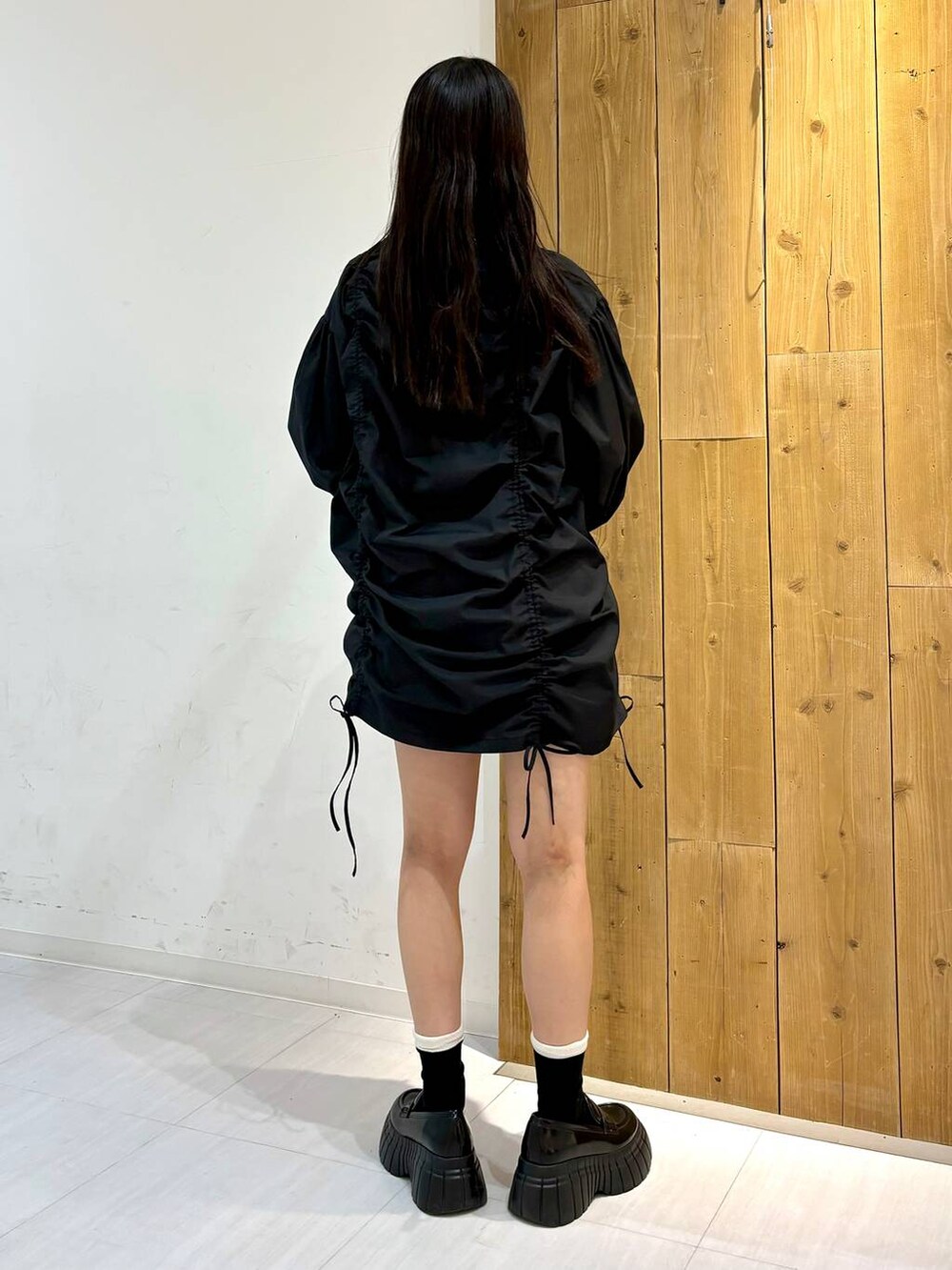 ブラック系のワンピース、ブラック系のローファー、ブラック系のボストンバッグを着用したレディースの春コーディネートの4枚目の写真