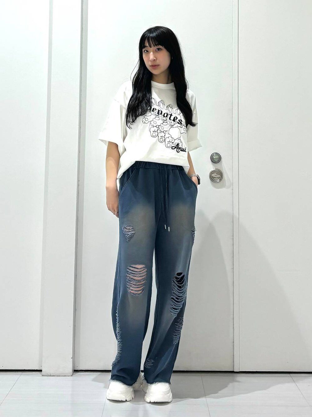 ホワイト系のスニーカー、ホワイト系のTシャツ/カットソー、ブルー系のスウェットパンツを着用したレディースの夏コーディネートの6枚目の写真