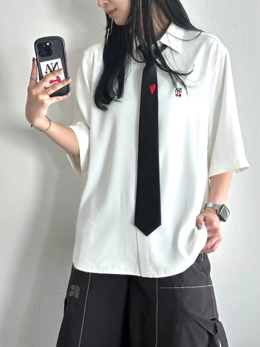 ブラック系のネクタイ、ブラック系のローファー、ホワイト系のシャツ/ブラウスを着用したレディースの春コーディネートの3枚目の写真