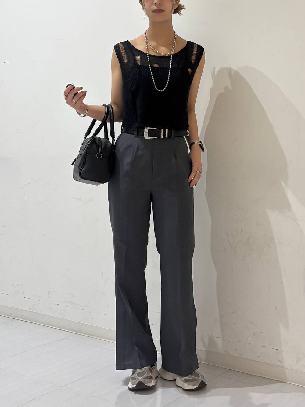 ブラック系のキャミソール、ブラック系のショルダーバッグ、ブラック系のベストを着用したレディースの夏コーディネートの2枚目の写真