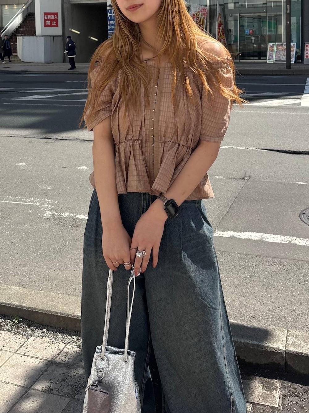 ブルー系のデニムパンツ、ブラウン系のシャツ/ブラウスを着用したレディースの春コーディネートの2枚目の写真