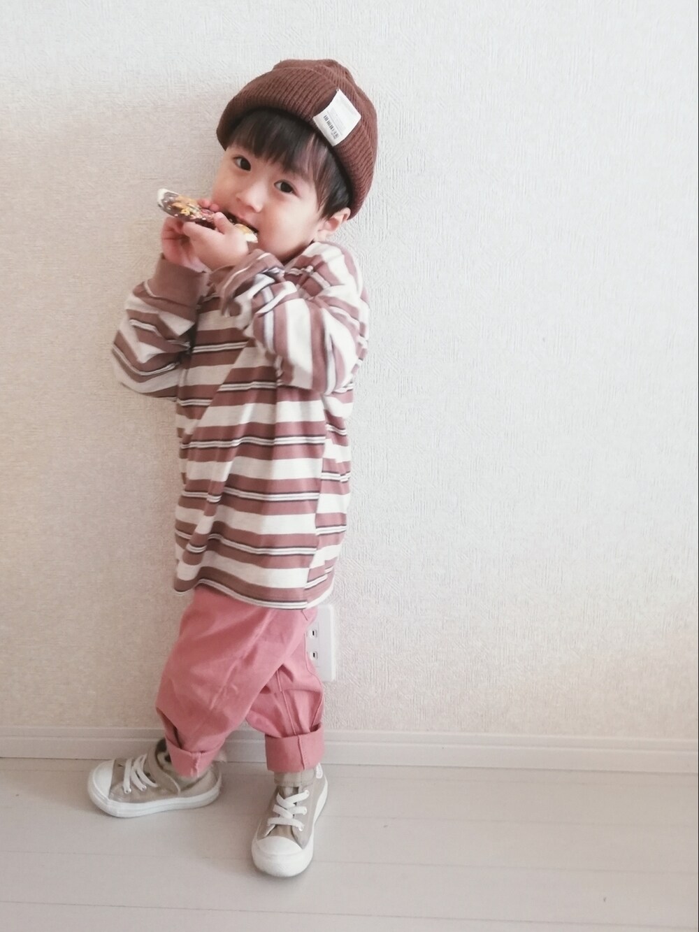 ベージュ系のTシャツ/カットソー、ピンク系のチノパンツ、ベージュ系のスニーカーを着用したキッズの冬コーディネートの3枚目の写真