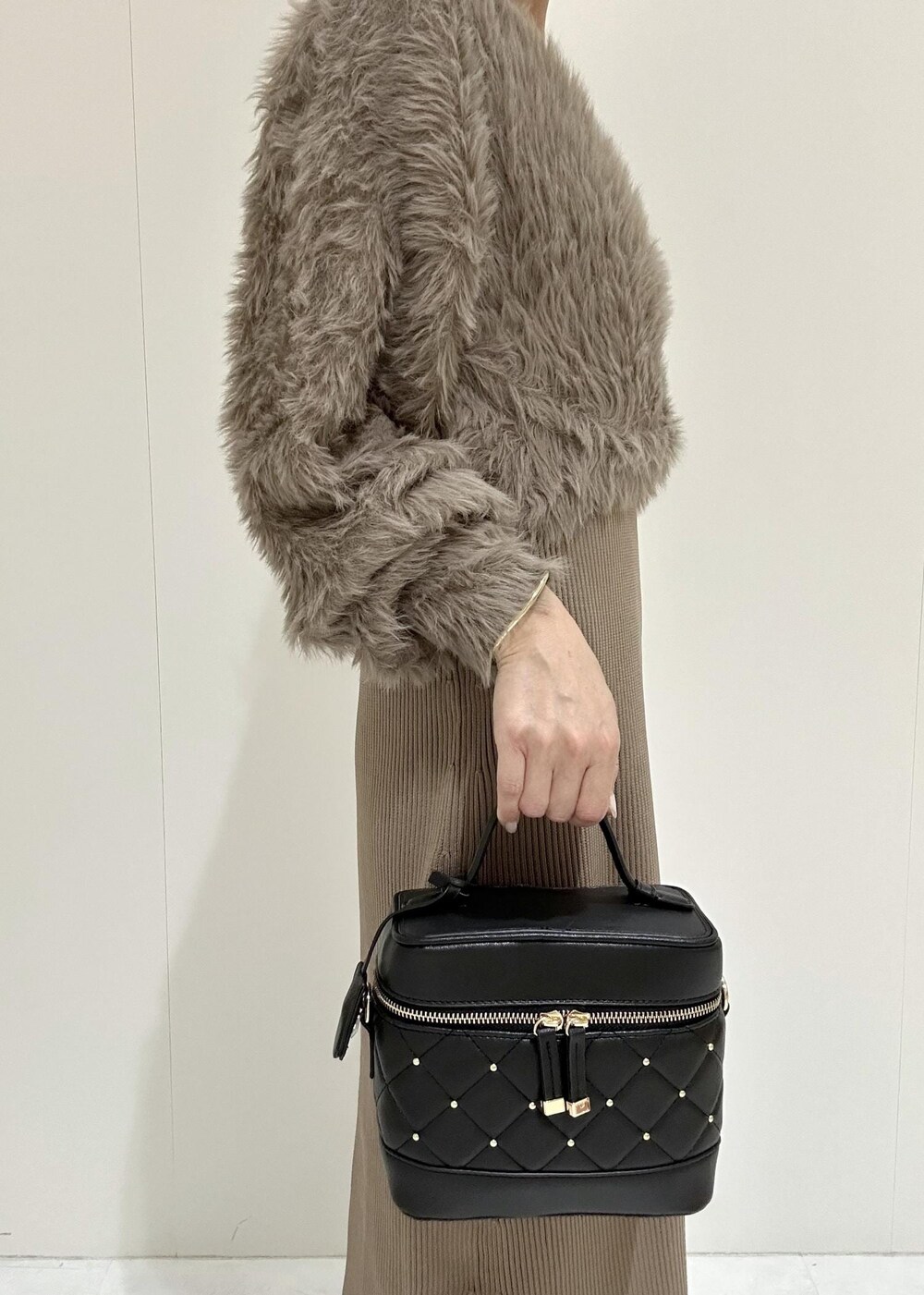 ブラック系のブーツ、ブラウン系のワンピース、ブラック系のハンドバッグを着用したレディースの秋コーディネートの9枚目の写真