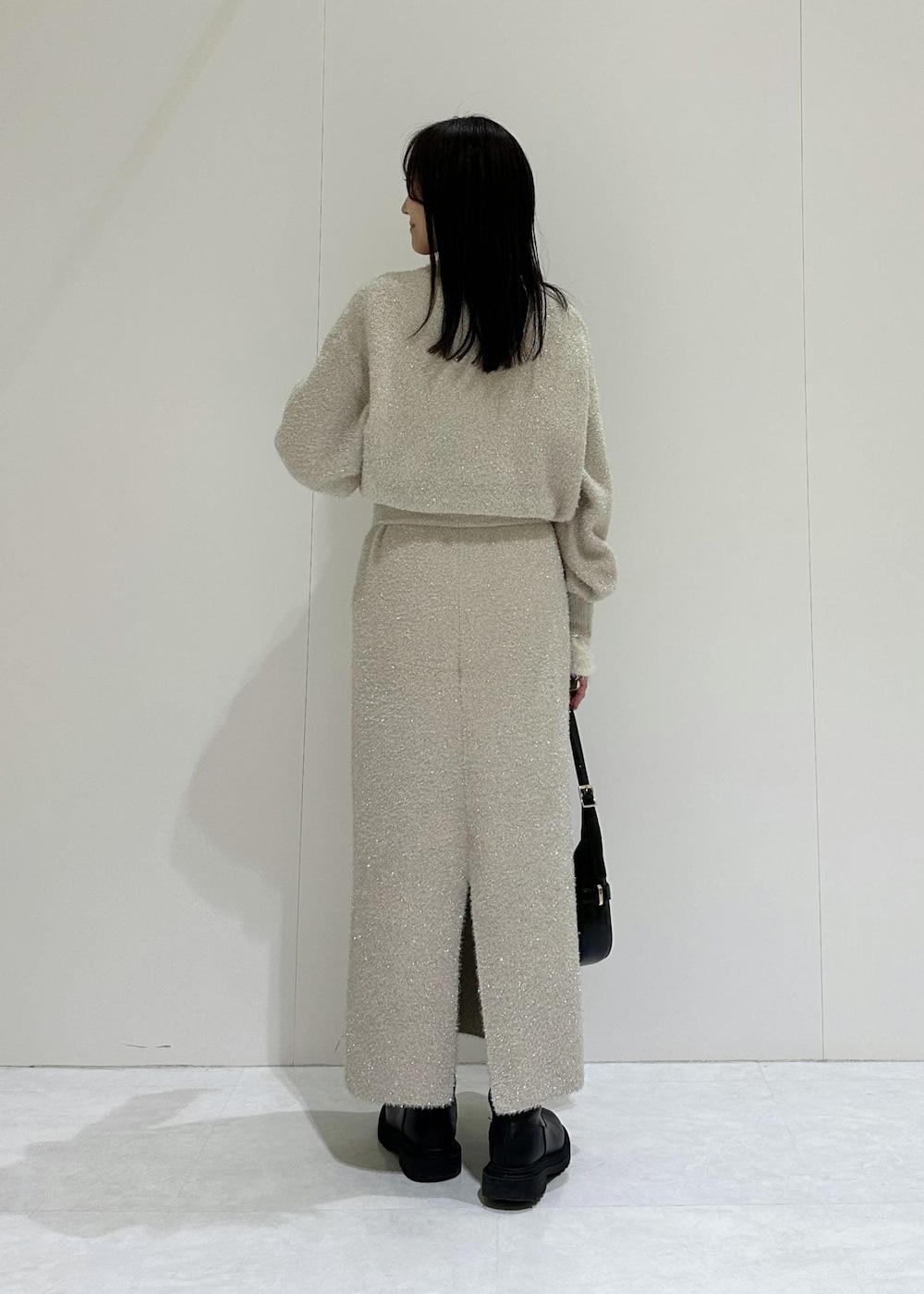 ベージュ系のスカート、ホワイト系のニット/セーター、ベージュ系のニット/セーターを着用したレディースの冬コーディネートの7枚目の写真