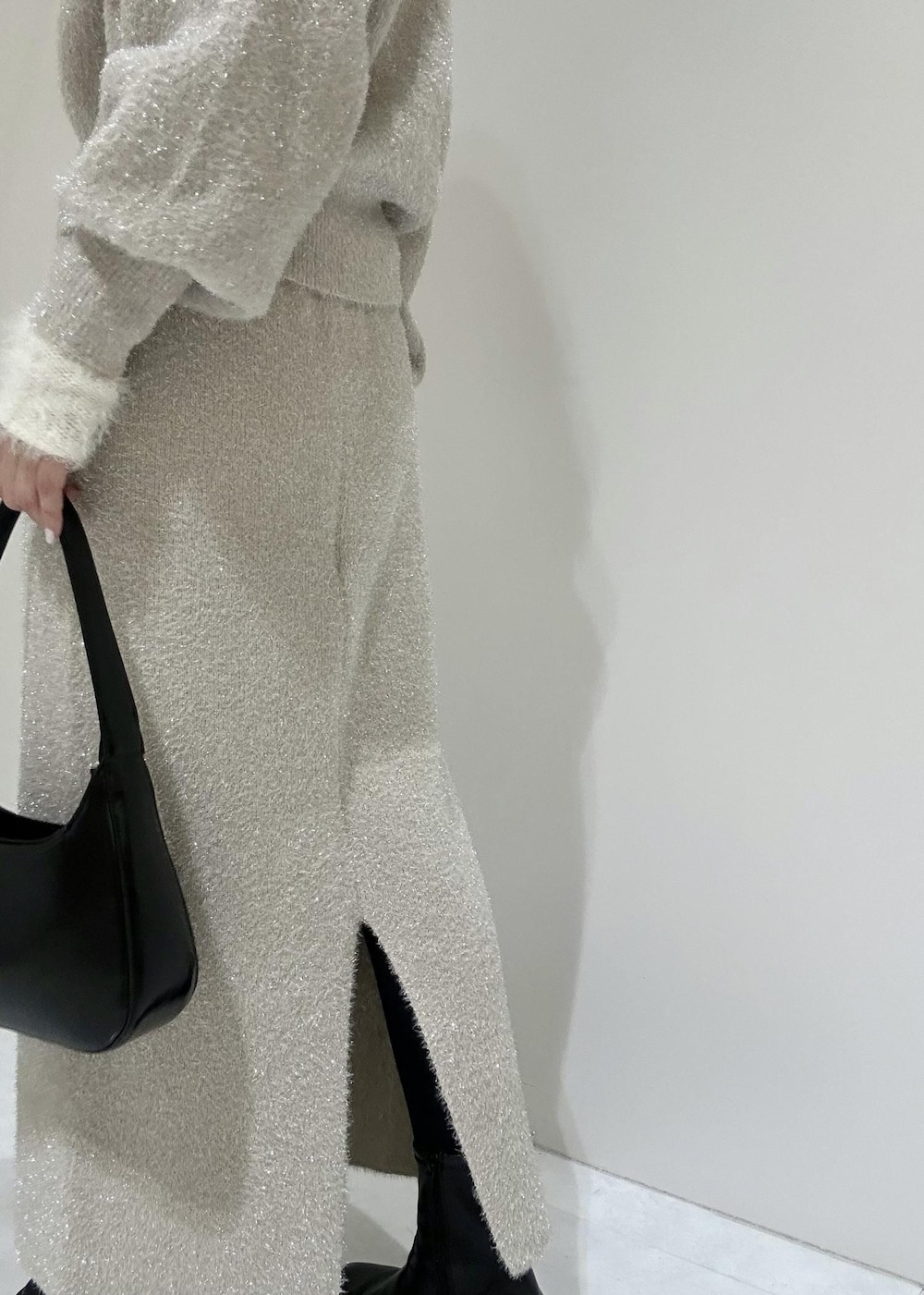 ベージュ系のスカート、ホワイト系のニット/セーター、ベージュ系のニット/セーターを着用したレディースの冬コーディネートの10枚目の写真