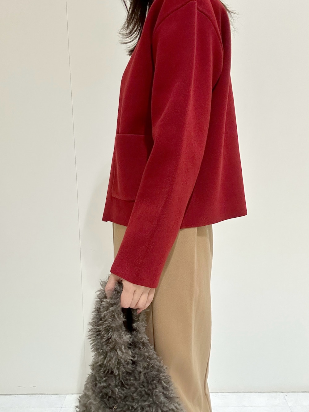 ホワイト系のTシャツ/カットソー、レッド系のカーディガン/ボレロ、イエロー系のスカートを着用したレディースの秋コーディネートの3枚目の写真