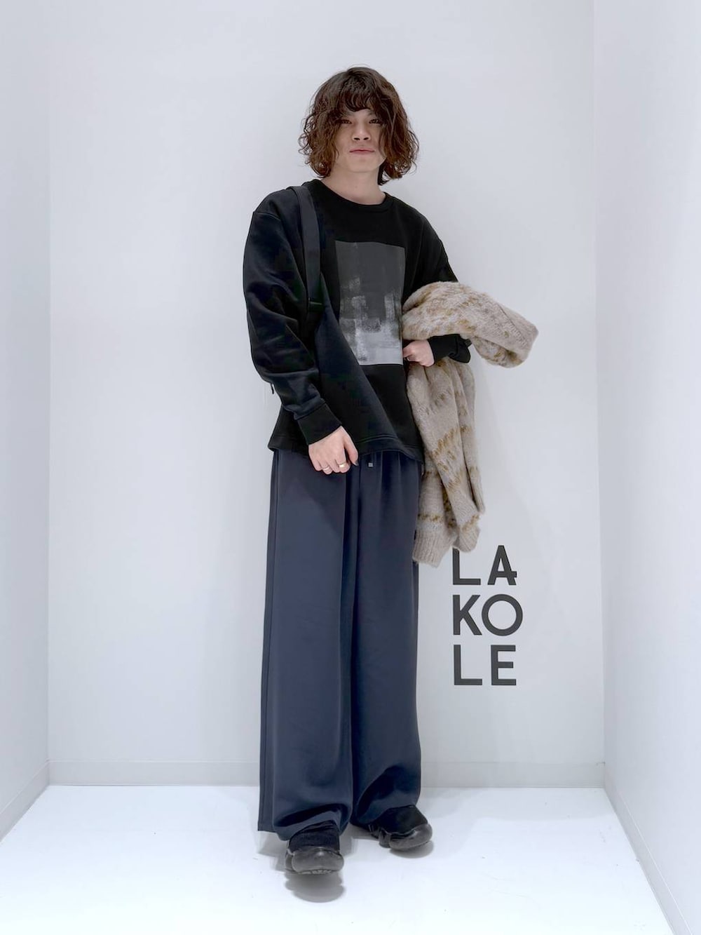 ベージュ系のカーディガン/ボレロ、ブラック系のショルダーバッグ、ブラック系のTシャツ/カットソーを着用したメンズの冬コーディネートの2枚目の写真