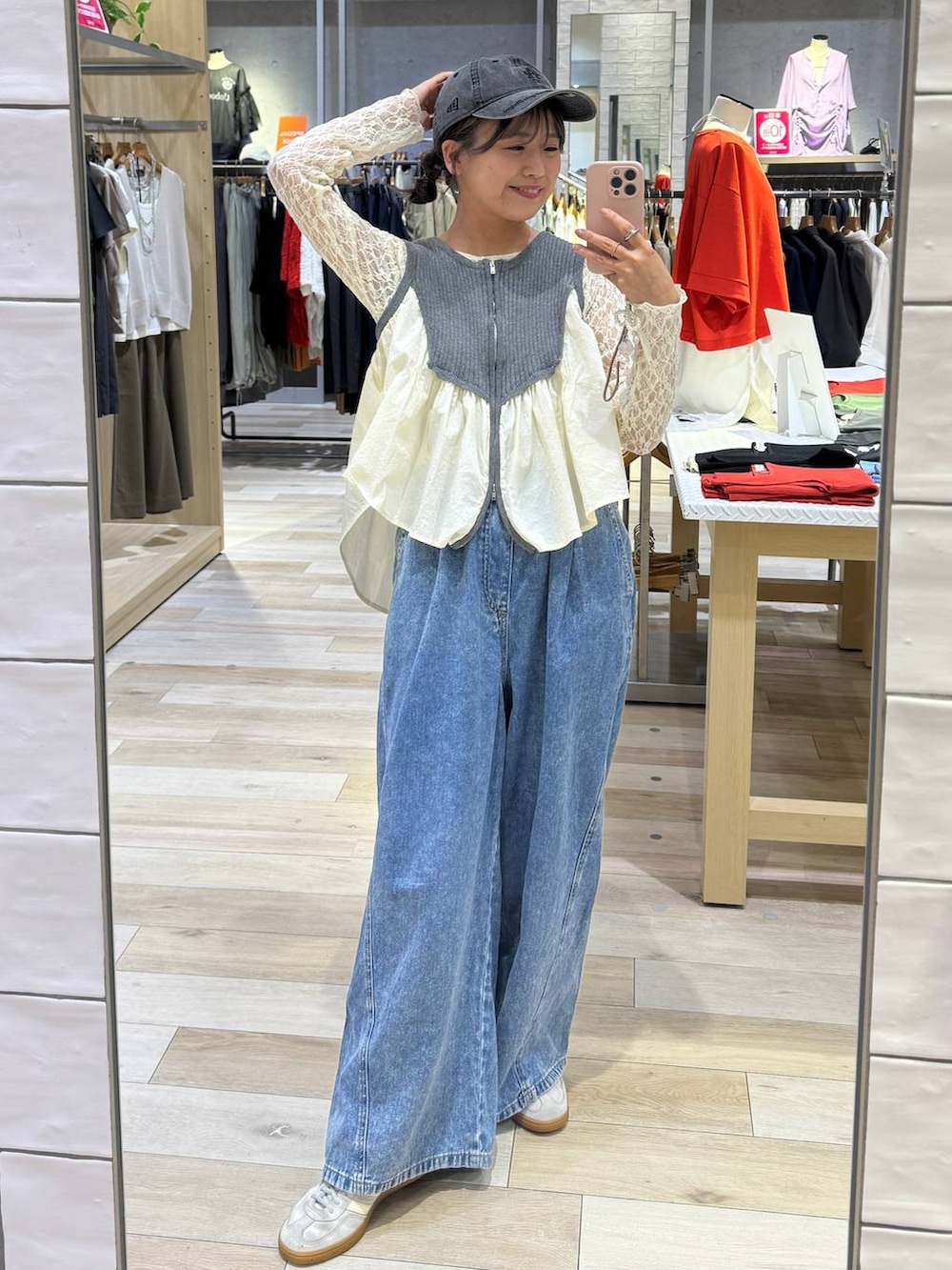 ブルー系のデニムパンツ、ホワイト系のシャツ/ブラウス、グレー系のベストを着用したレディースの春コーディネートの2枚目の写真
