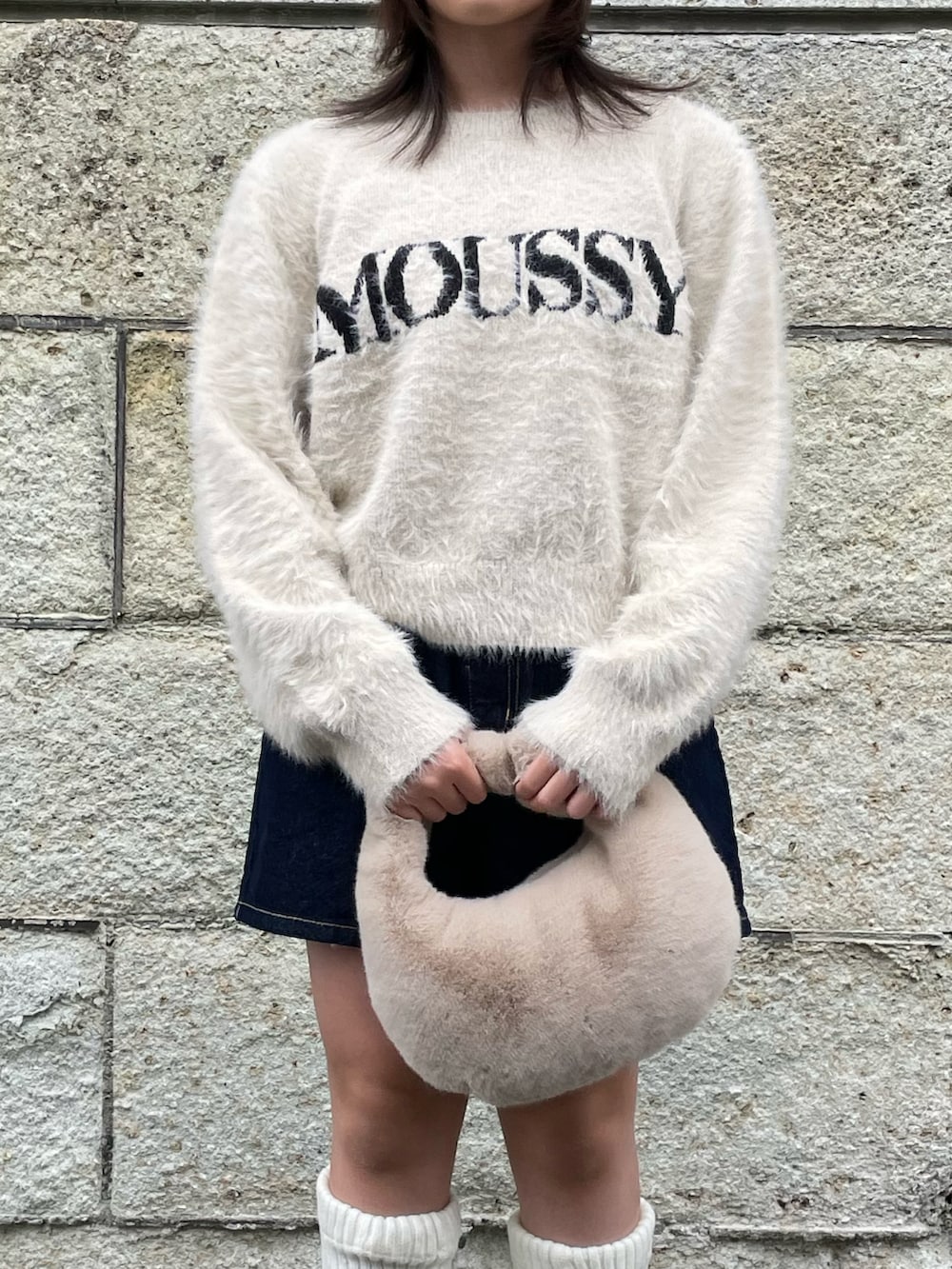 ホワイト系のニット/セーター、ブルー系のデニムパンツ、ベージュ系のハンドバッグを着用したキッズの秋コーディネートの5枚目の写真