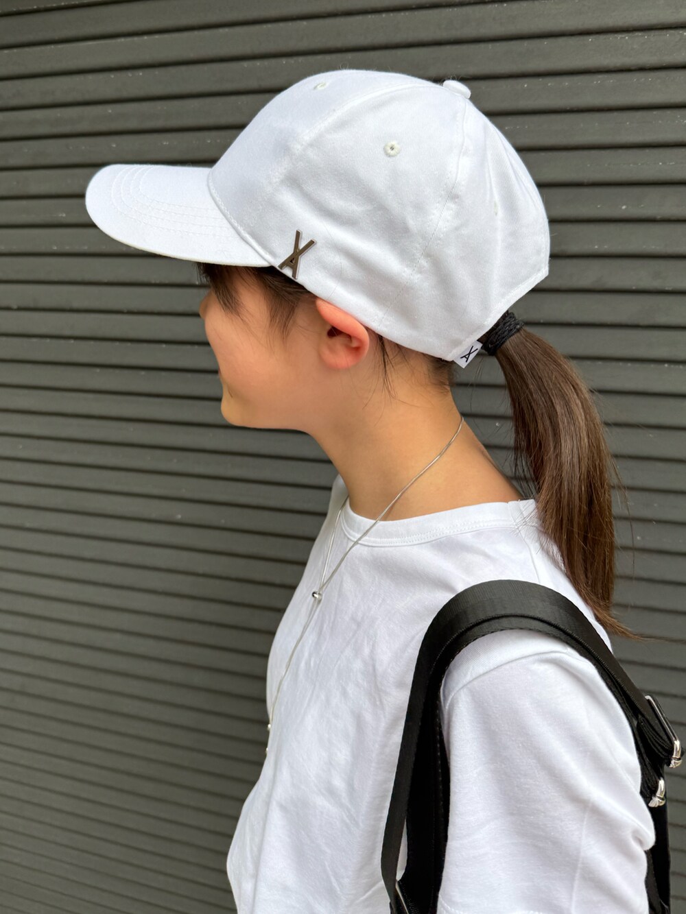 ホワイト系のデニムパンツ、ホワイト系のTシャツ/カットソー、ブラック系のショルダーバッグを着用したキッズの春コーディネートの5枚目の写真