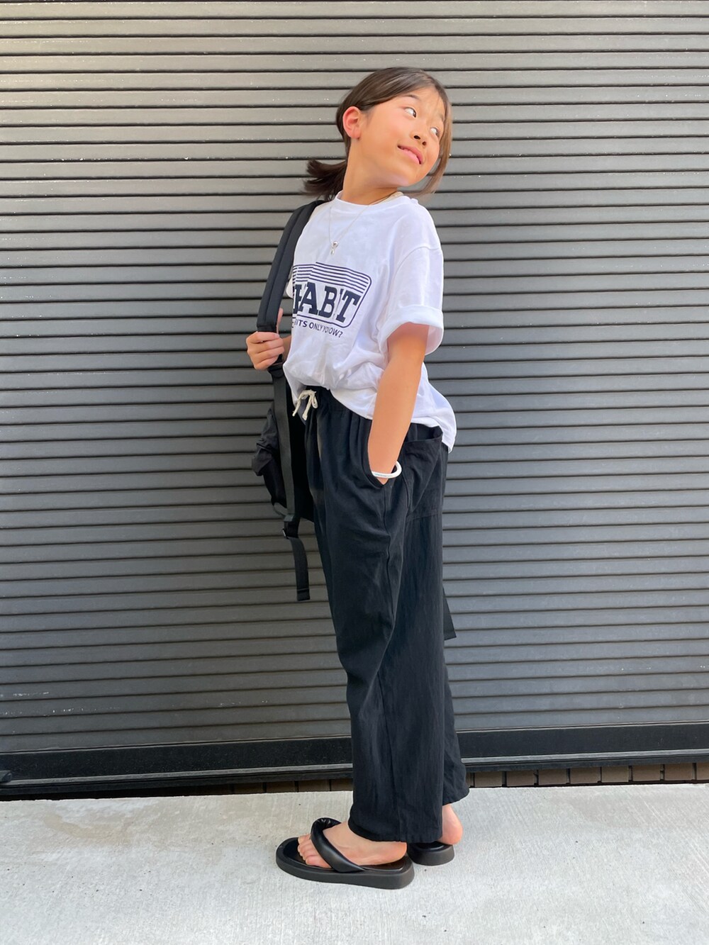ホワイト系のTシャツ/カットソー、ブラック系のその他パンツ、ブラック系のバックパック/リュックを着用したキッズの春コーディネートの3枚目の写真