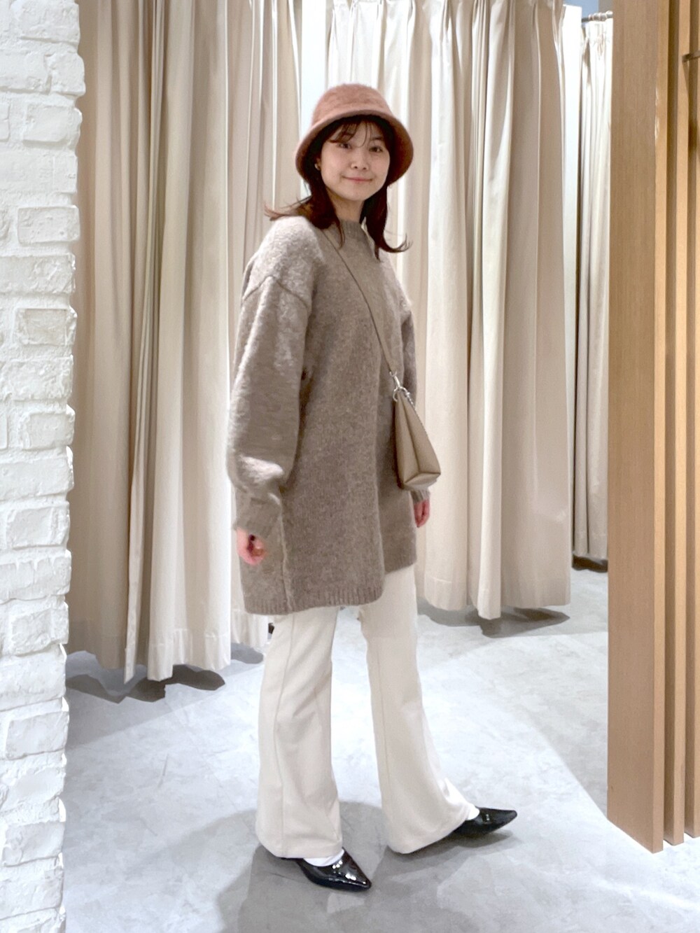 ブラウン系のワンピース、ベージュ系のその他パンツ、ベージュ系のショルダーバッグを着用したレディースの冬コーディネートの2枚目の写真