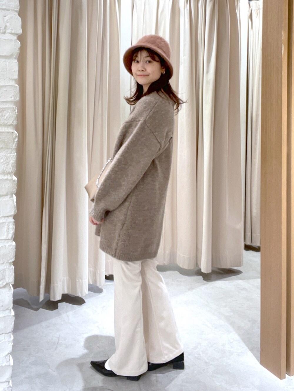 ブラウン系のワンピース、ベージュ系のその他パンツ、ベージュ系のショルダーバッグを着用したレディースの冬コーディネートの3枚目の写真