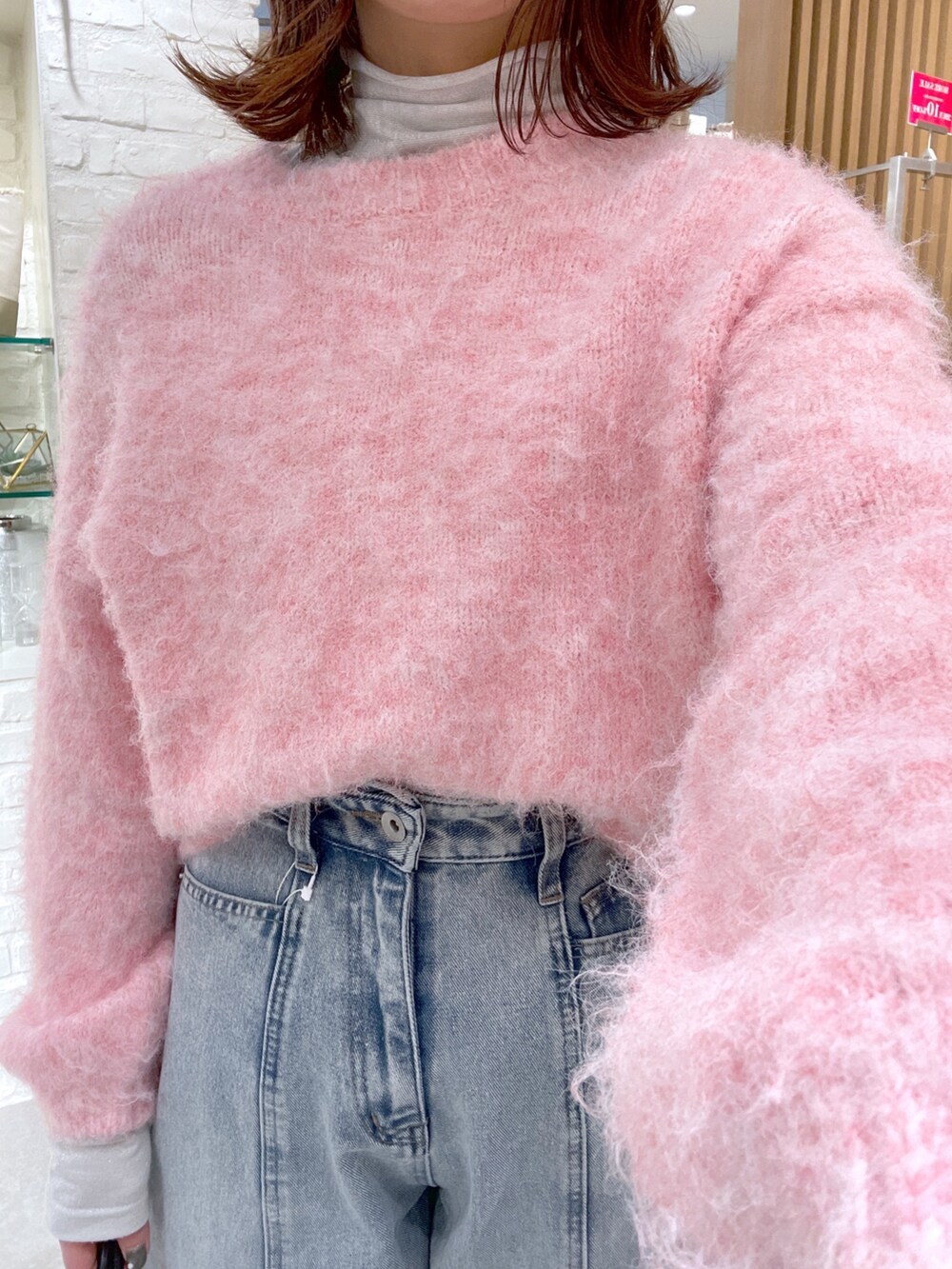 ブルー系のデニムパンツ、ブラック系のショルダーバッグ、シルバー系のパンプスを着用したレディースの冬コーディネートの7枚目の写真