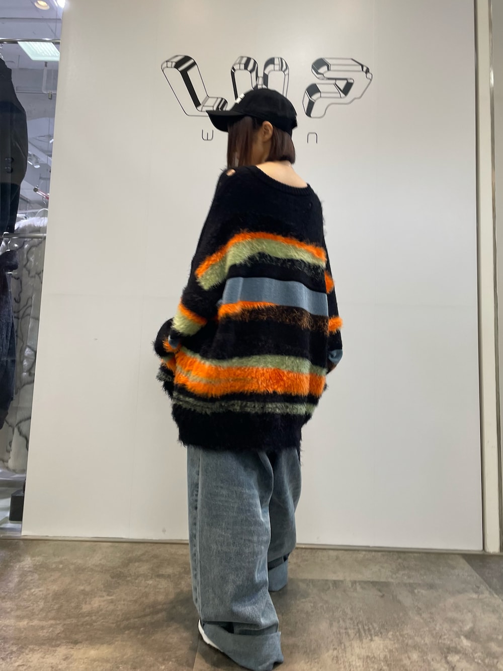 その他のニット/セーター、その他のデニムパンツ、ブラック系のキャップを着用したレディースの秋コーディネートの2枚目の写真
