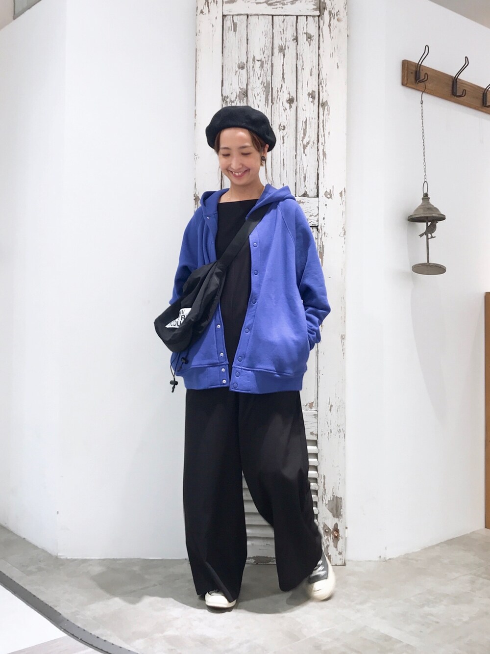 ブルー系のブルゾン、ブラック系のサロペット/オーバーオール、ブラック系のスニーカーを着用したレディースの夏コーディネートの3枚目の写真